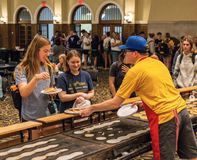 Students getting pancakes from Pancake Man.