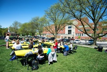 group of student outside sitting at tables