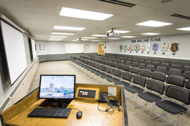 Five rows of twenty chairs each with a whiteboard, projector, and podium. 