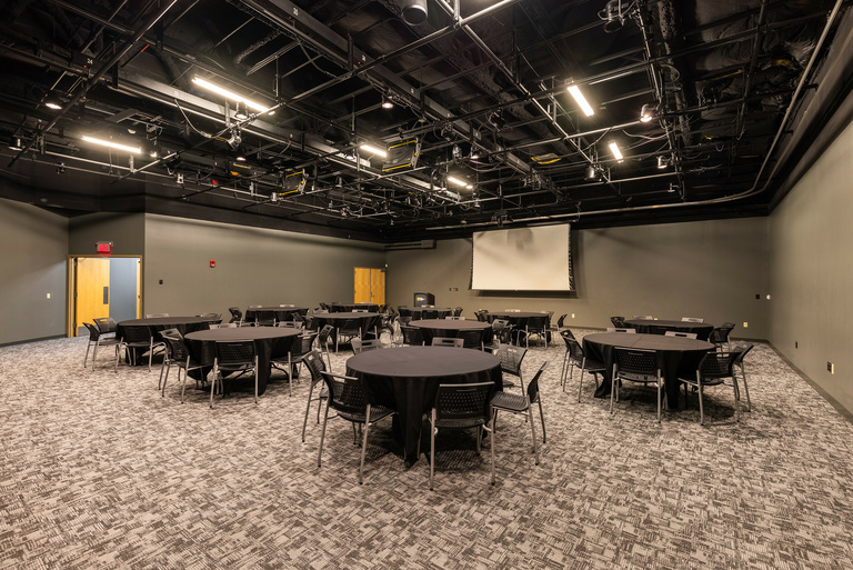 black box theater with round tables