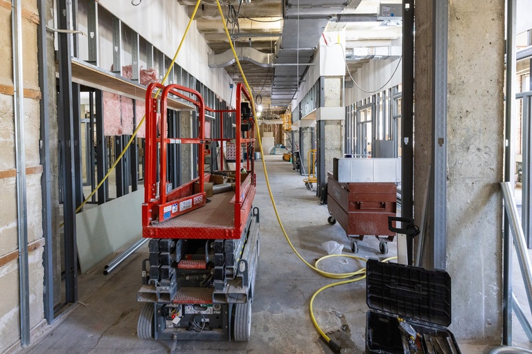 Future space of the Wellness Center looking east with construction equipment and tools.