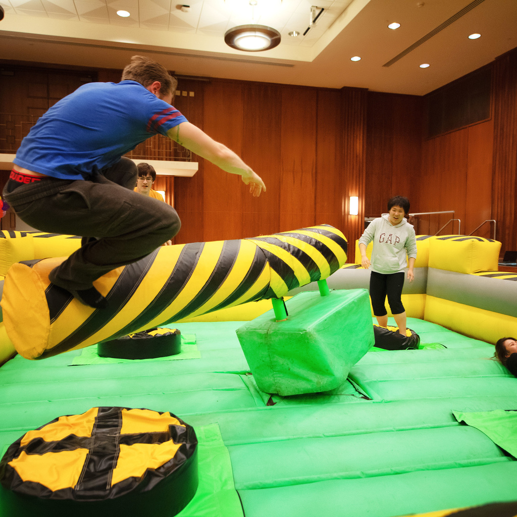 man jumping in an inflatable playroom