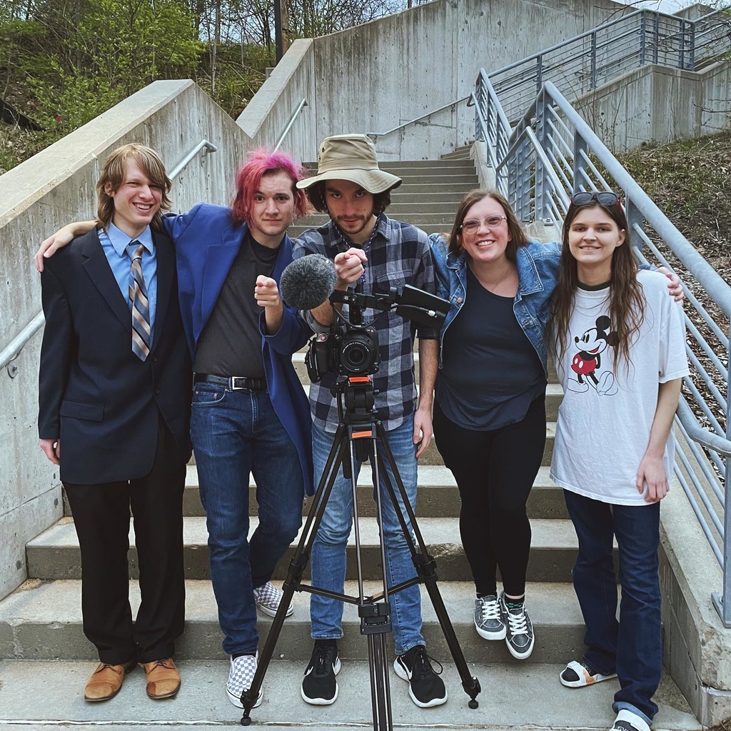 students standing together in front of video camera