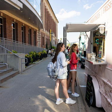 Students ordering at a food truck outside the IMU.