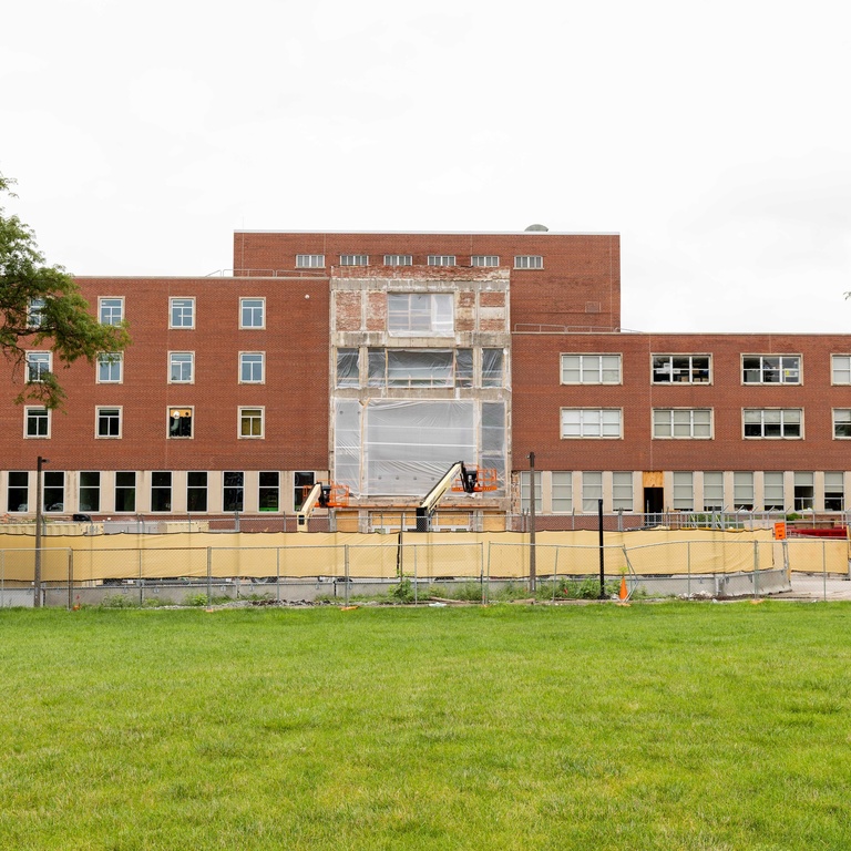 south entrance of the IMU with construction equipment, parking space blocked off.