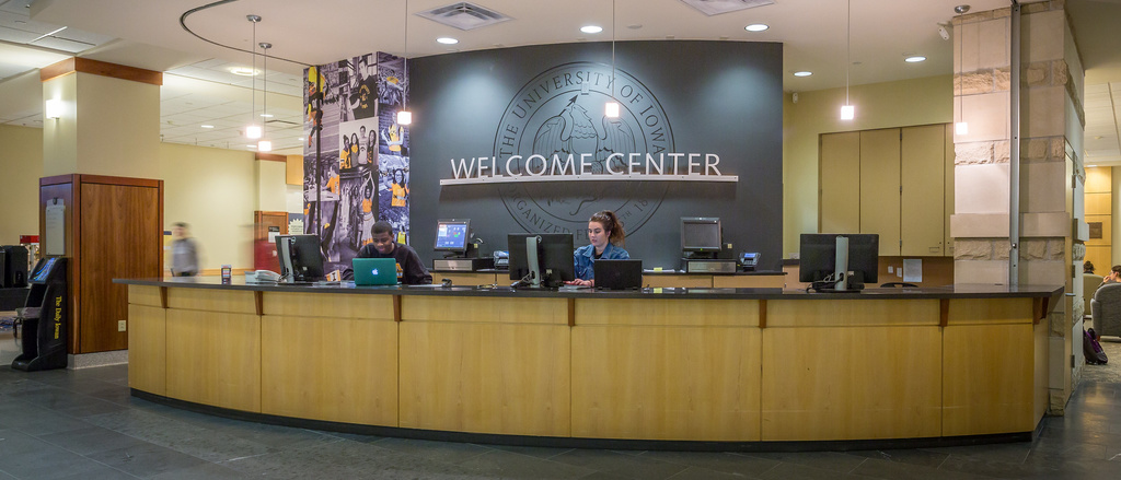 student behind desk at welcome center