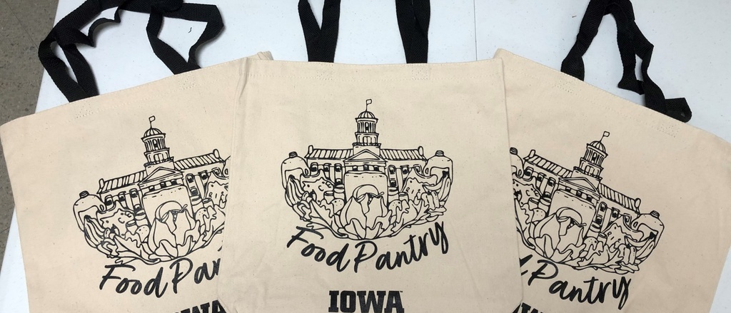 Three canvas bags with an illustration of the old capitol and the text "Food Pantry at Iowa" on them