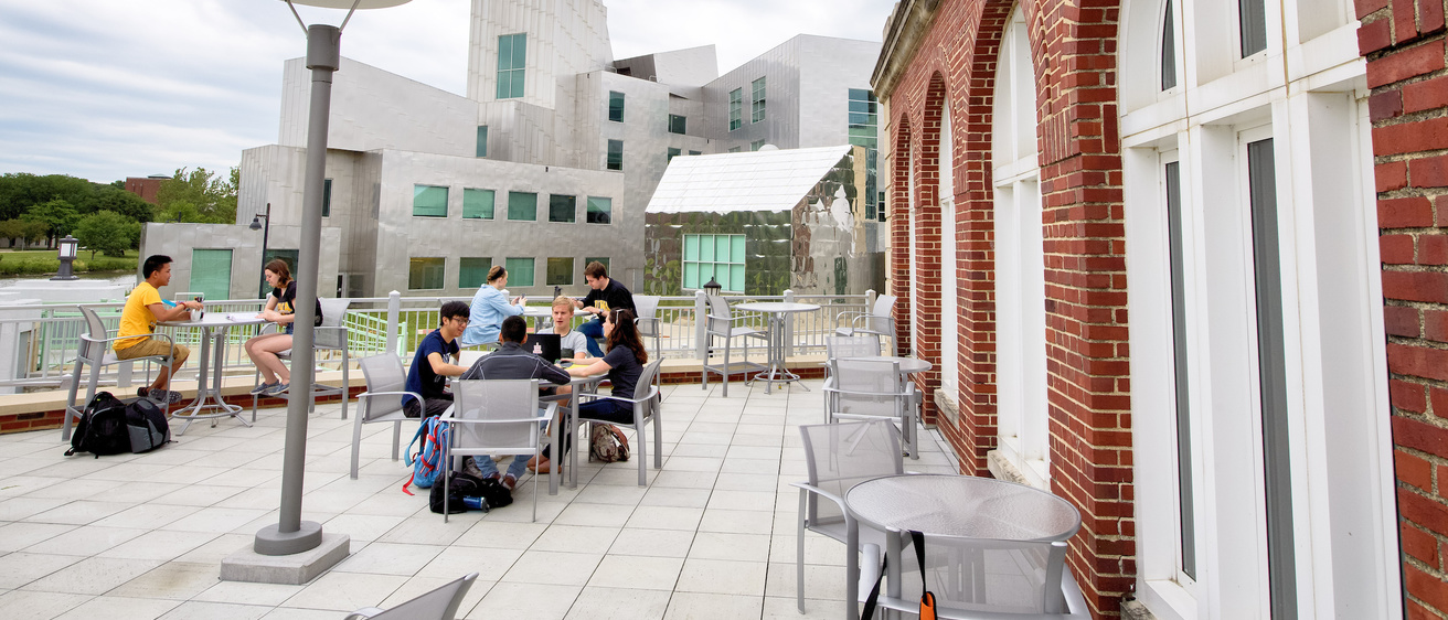 student dining outside on the imu terrace