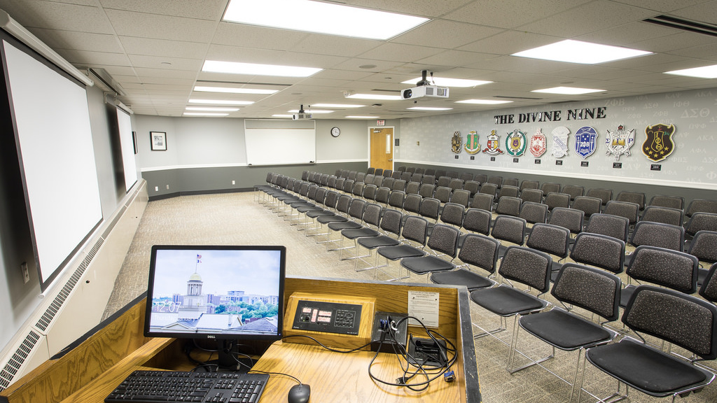 Five rows of twenty chairs each with a whiteboard, projector, and podium. 
