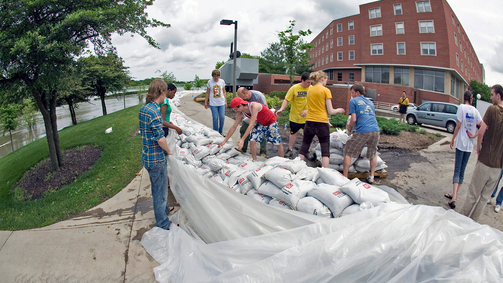 students stacking sandbags outside the IMU