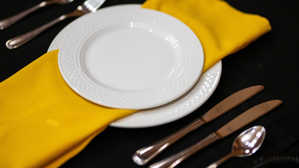 Place setting with gold napkin and white plate
